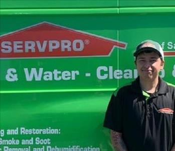 Male employee in front of the van