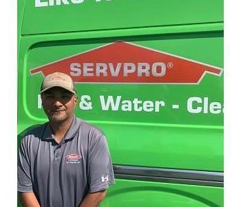 Male employee in front of van