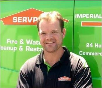 Male owner in front of van