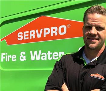 Male owner in front of van