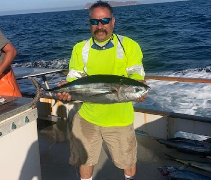 Male employee Holding a Fish