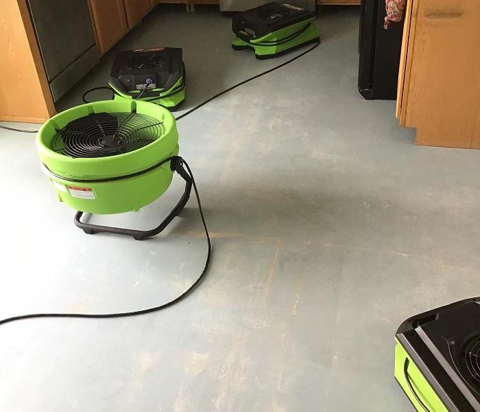 Kitchen being dried after a slab leak 